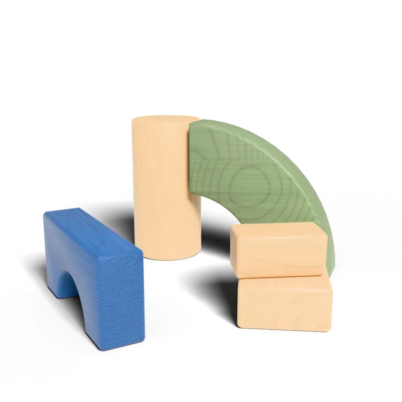 Wooden toy blocks — an arch, a column, a curve and two bricks — standing as one structure